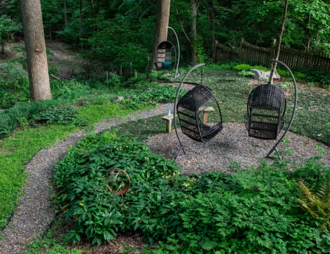 Two wicker swing chairs provide a relaxing way to view the native plant surroundings at Barbara Schubert's home. Photo by Ben Israel.